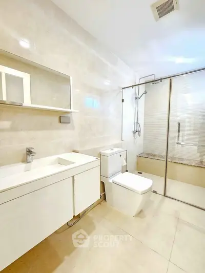 Modern bathroom with sleek fixtures and glass shower enclosure