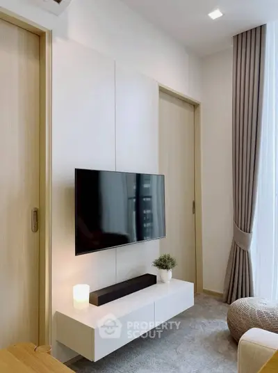 Modern living room with wall-mounted TV and elegant decor