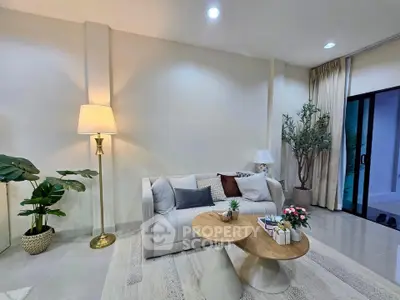 Elegant living room with modern decor, cozy sofa, and stylish lighting