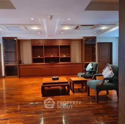 Spacious living room with elegant wooden flooring and stylish furniture