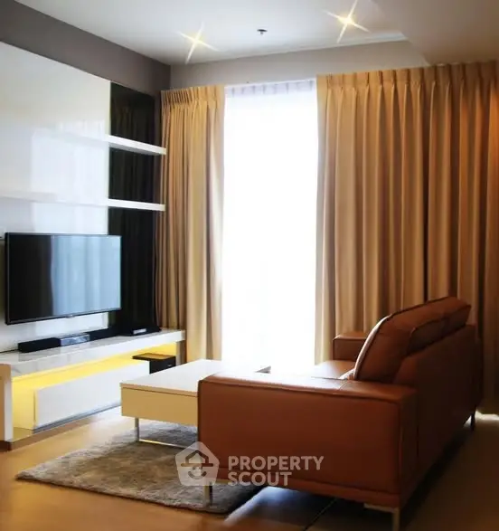 Modern living room with sleek furniture and large window