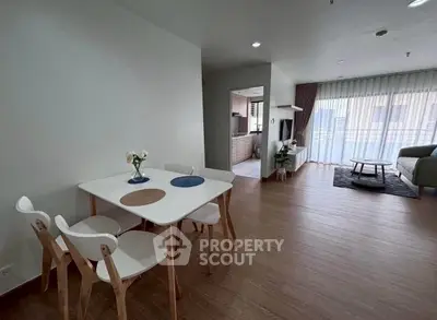 Modern open-plan living room with dining area and large windows