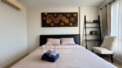 Modern bedroom with stylish decor and natural light, featuring a comfortable bed and elegant furnishings.