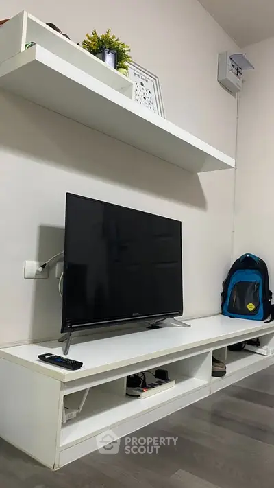 Modern living room with sleek TV setup and stylish shelving, perfect for contemporary urban living.