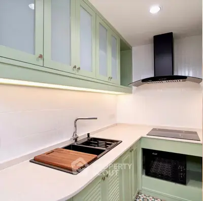 Charming kitchen with mint green cabinets and modern appliances
