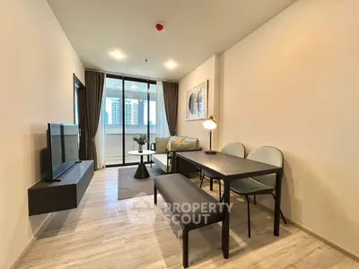 Modern living room with sleek furniture and city view balcony