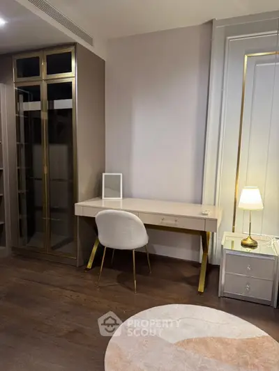 Elegant study area with modern desk, chair, and lamp in a stylish interior setting.