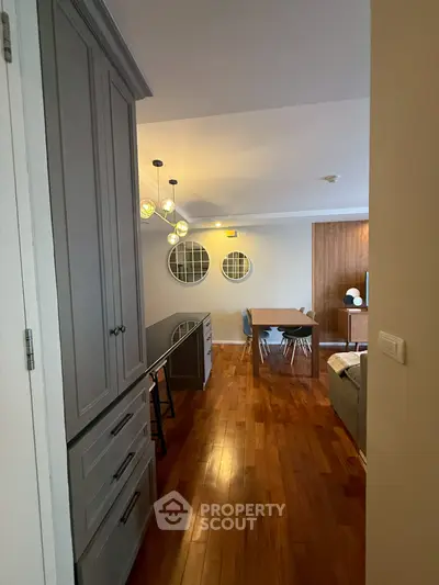 Stylish apartment interior with modern dining area and elegant lighting fixtures.