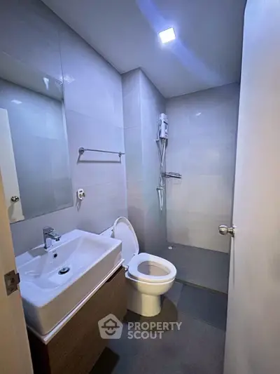 Modern bathroom with sleek fixtures and minimalist design in a contemporary apartment.