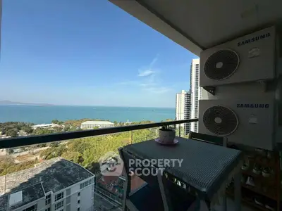 Stunning balcony view with ocean and cityscape, perfect for relaxation.