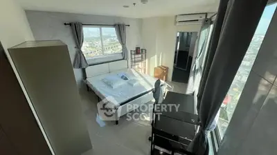 Bright bedroom with city view, modern furnishings, and ample natural light.