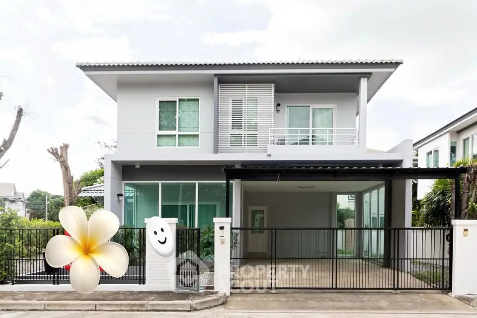 Modern two-story house with sleek design and spacious driveway in a serene neighborhood.