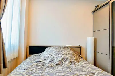 Cozy bedroom with modern decor and ample natural light