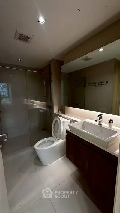 Modern bathroom with sleek fixtures and glass shower enclosure