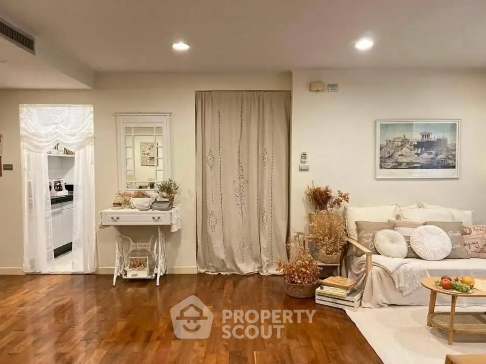 Charming living room with elegant decor and warm wooden flooring, perfect for cozy gatherings.