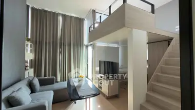 Modern loft-style living room with high ceilings and elegant decor