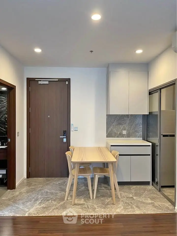 Modern kitchen with sleek design and dining area in contemporary apartment