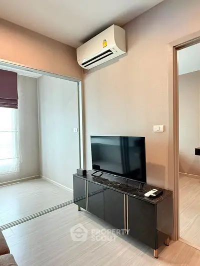 Modern living room with sleek TV stand and air conditioning unit