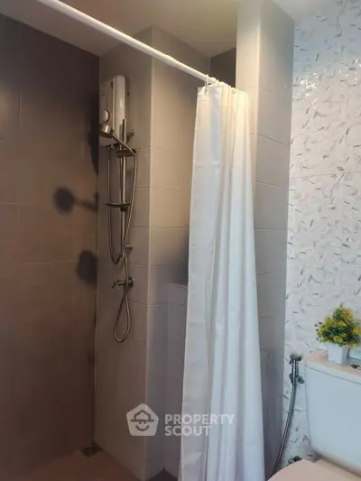 Modern bathroom with shower and stylish tile design