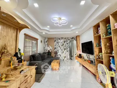 Spacious living room with modern decor and elegant lighting, featuring a cozy seating area and stylish wooden furniture.