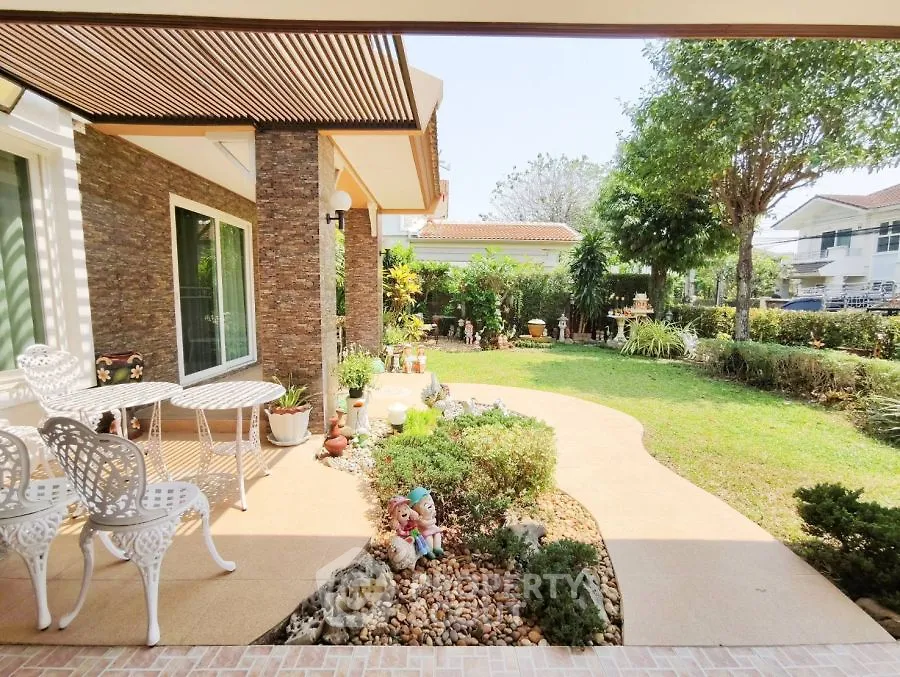 Charming garden view with elegant patio furniture and lush greenery