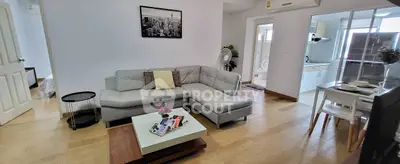 Modern living room with stylish furniture and open kitchen layout in a cozy apartment.