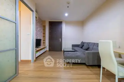 Modern living room with cozy gray sofa and wooden flooring