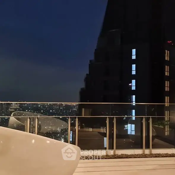 Stunning rooftop view with city skyline at night, perfect for urban living.
