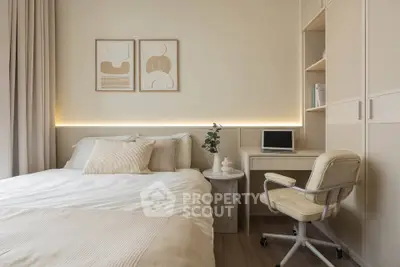 Cozy bedroom with modern decor and study area, featuring neutral tones and stylish furnishings.