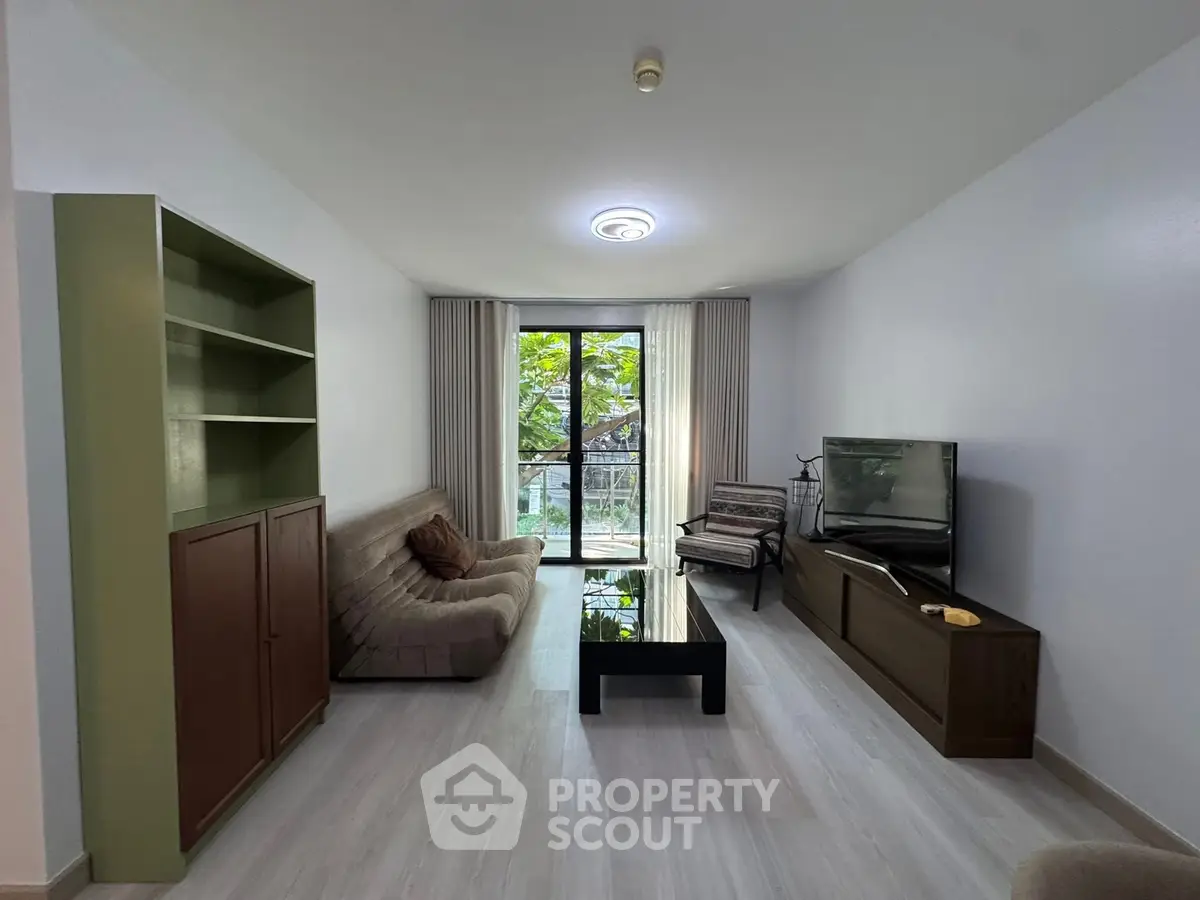 Spacious living room with modern furniture and large window view