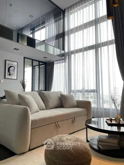 Luxurious modern living room with high ceilings and large windows