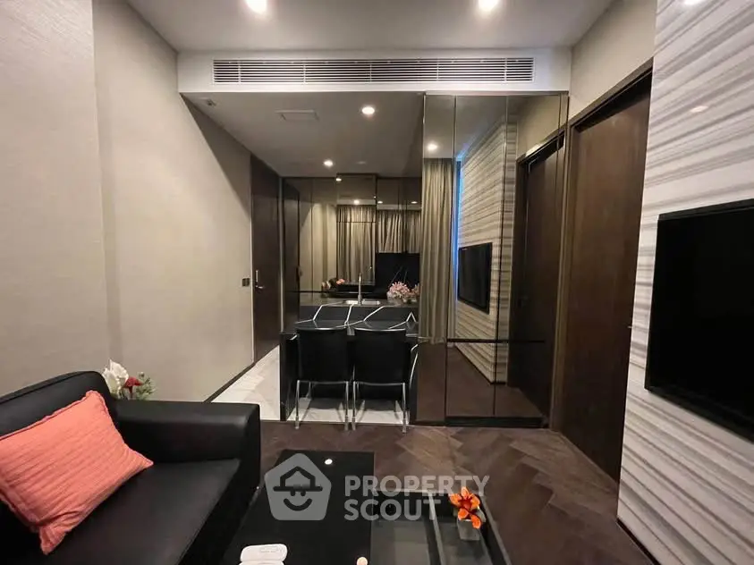 Modern living room with sleek design, mirrored walls, and stylish furniture in a luxury apartment.