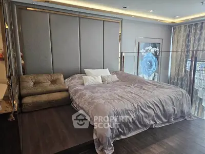 Luxurious bedroom with elegant decor and large bed in modern apartment.
