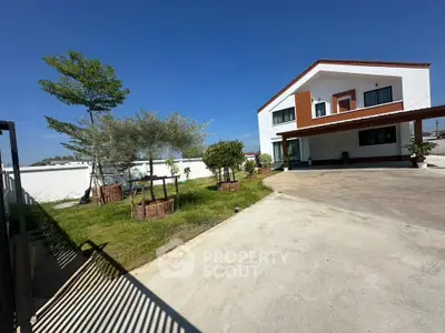 Spacious modern house with large driveway and lush garden, perfect for family living.
