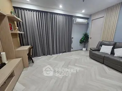 Modern living room with sleek design, featuring a cozy sofa, elegant curtains, and stylish shelving.