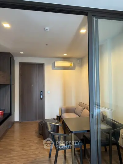 Modern living room with sleek furniture and wooden flooring in a stylish apartment.