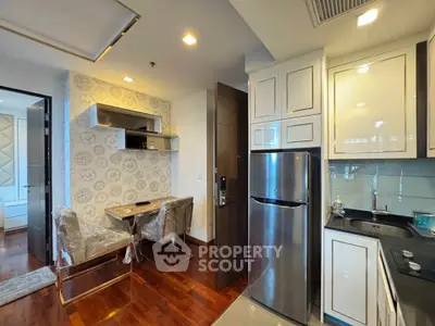 Modern kitchen with sleek cabinetry and dining area in a stylish apartment