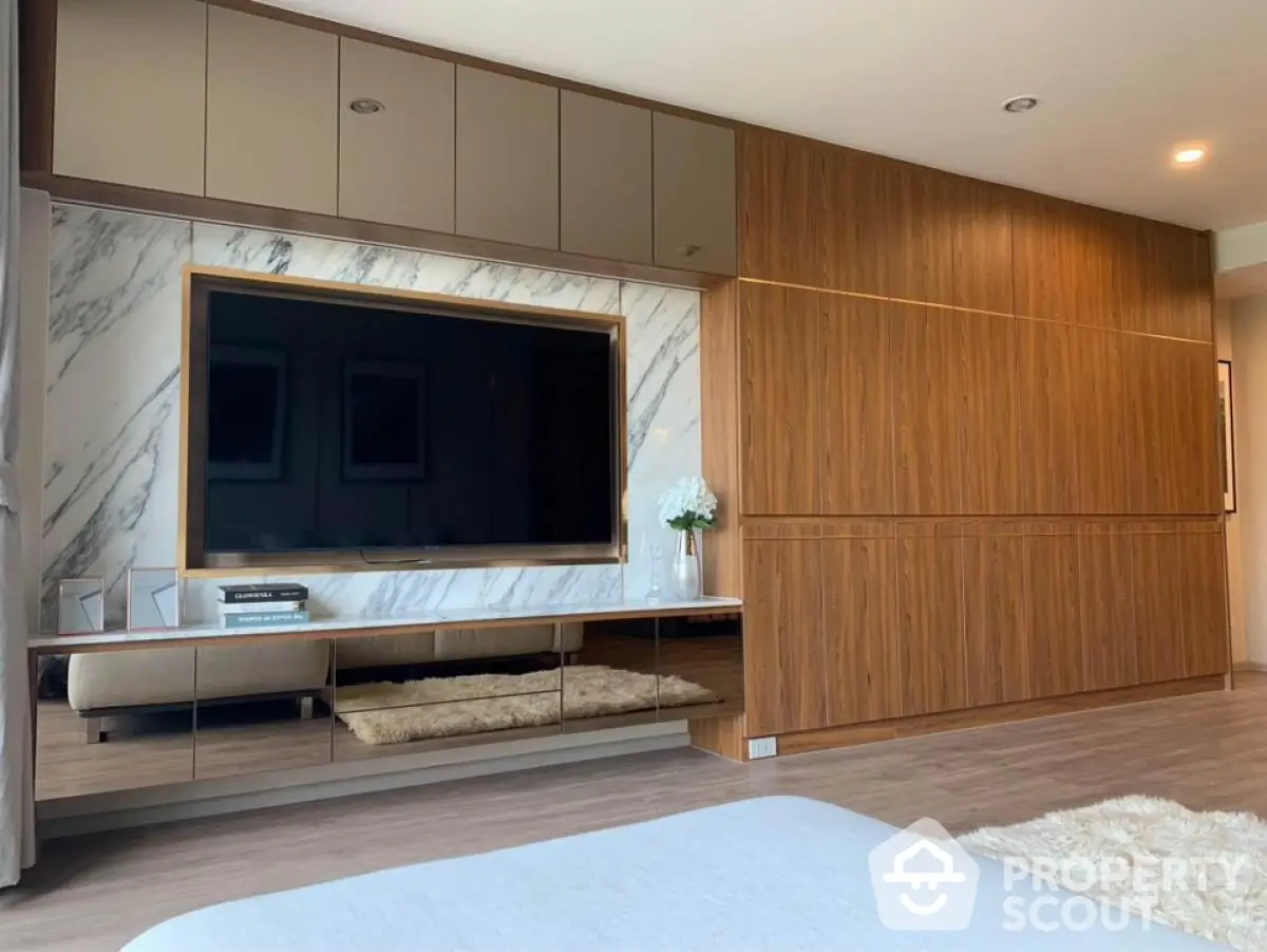 Luxurious modern living room with sleek wood paneling and large flat-screen TV