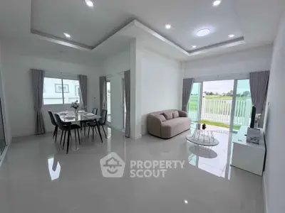 Spacious modern living room with dining area and large windows offering scenic views.