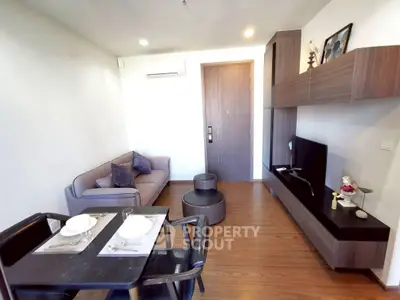 Modern living room with sleek furniture and wooden flooring, perfect for cozy gatherings.