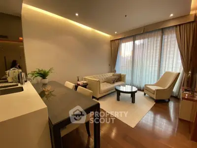 Elegant living room with modern furniture and large window in a cozy apartment.