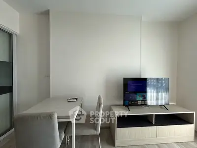Modern living room with sleek TV stand and dining table, perfect for cozy urban living.