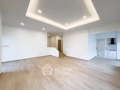 Spacious modern living room with recessed lighting and open layout