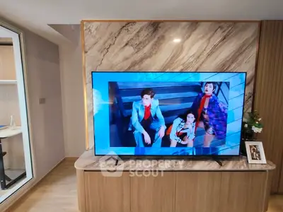 Modern living room with stylish TV setup and elegant marble backdrop