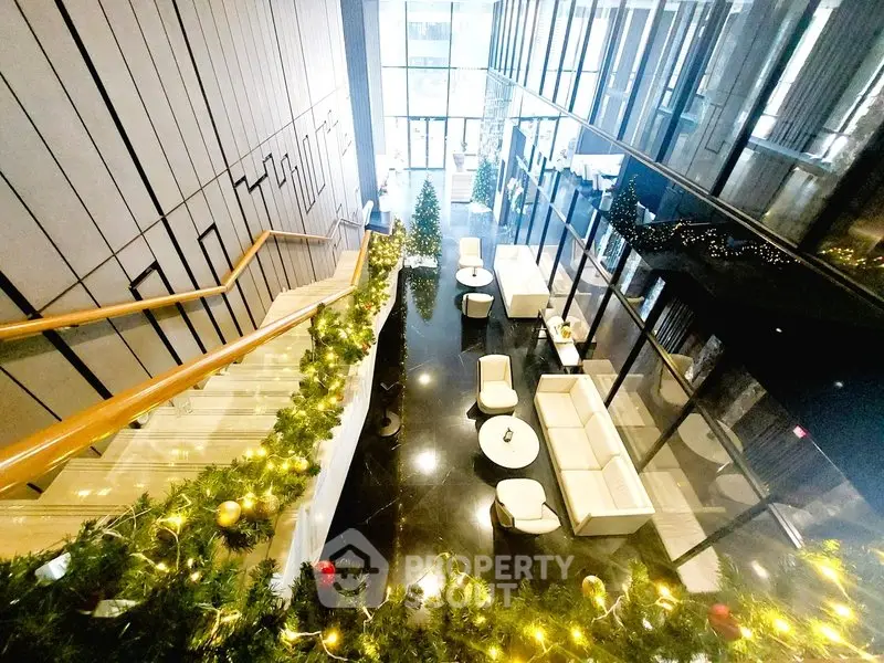 Luxurious building entrance with festive decor and elegant seating area