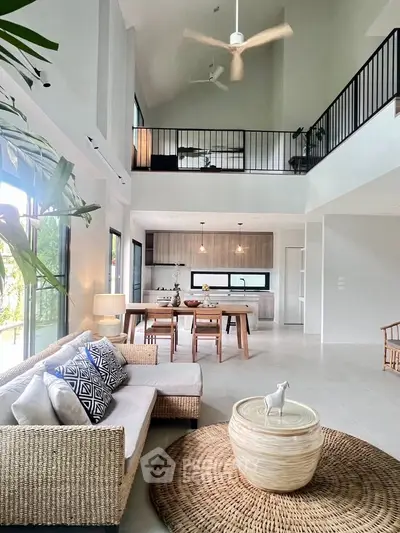 Spacious modern living room with high ceilings and open kitchen layout