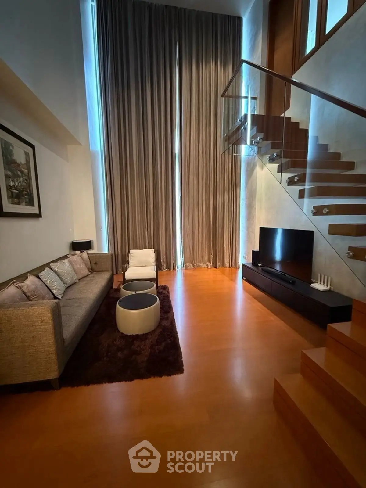 Luxurious living room with high ceilings and elegant staircase