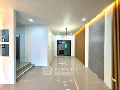 Spacious modern interior with elegant lighting and sleek tile flooring, perfect for contemporary living.