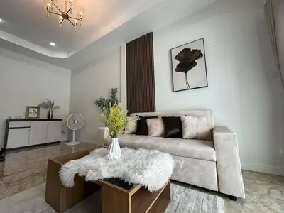 Elegant living room with modern decor and plush sofa, perfect for relaxation.