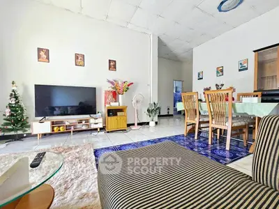 Spacious living room with modern decor and dining area, perfect for family gatherings.